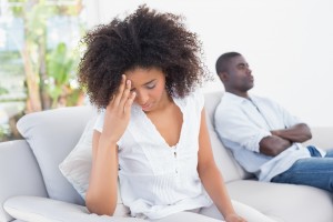 Attractive couple having an argument on couch at home in the liv